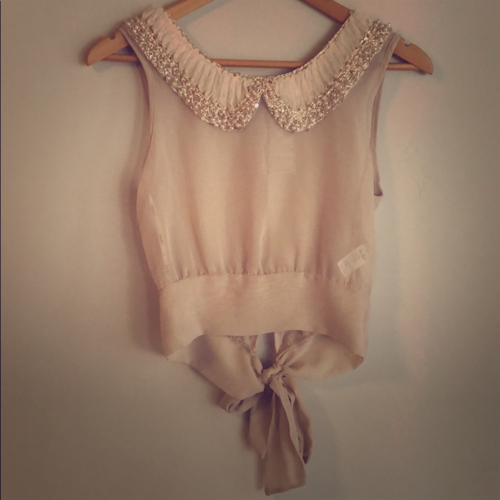 Cute top with sequence and pearl beads.
